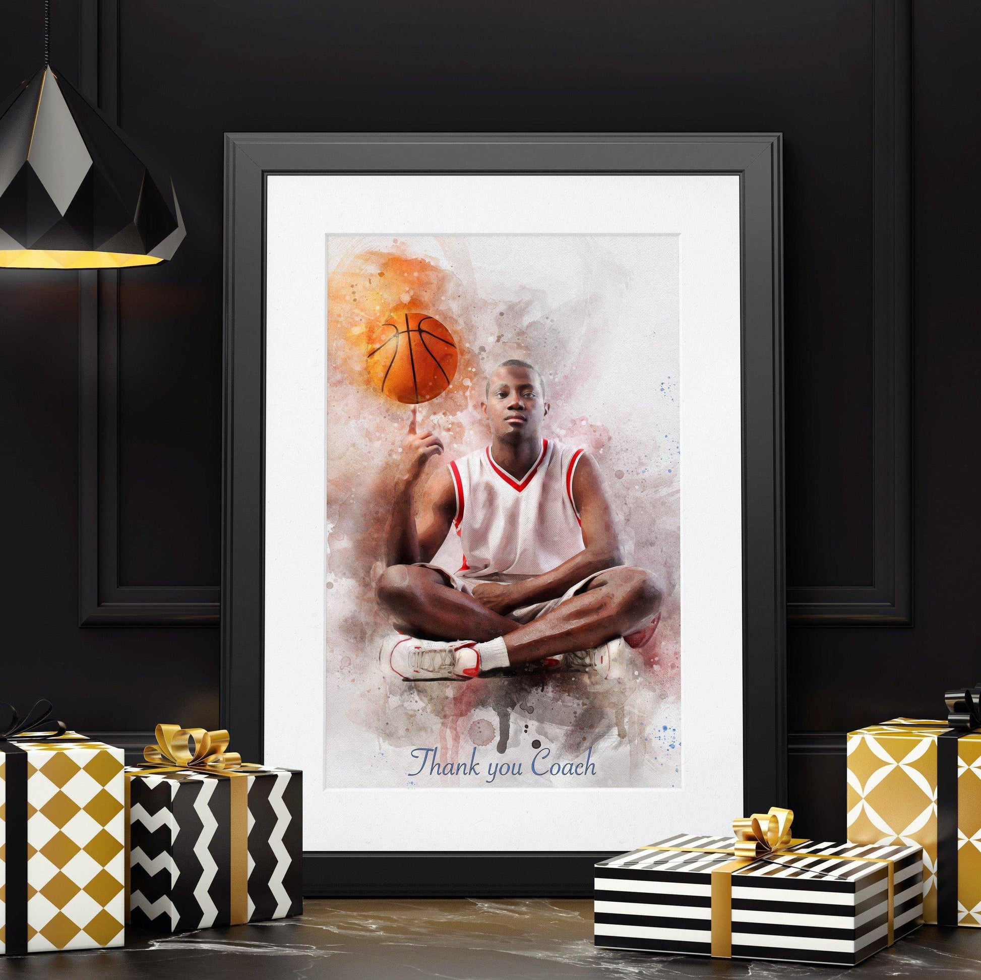 A framed watercolor-style portrait of a seated male basketball player in a white and red jersey, balancing a basketball on his finger. The text "Thank you Coach" is subtly visible at the bottom of the artwork, making it an ideal example of Custom Basketball Gifts. The framed print is surrounded by elegantly wrapped gift boxes in gold, black, and white patterns, set against a dark background with a modern black light fixture.