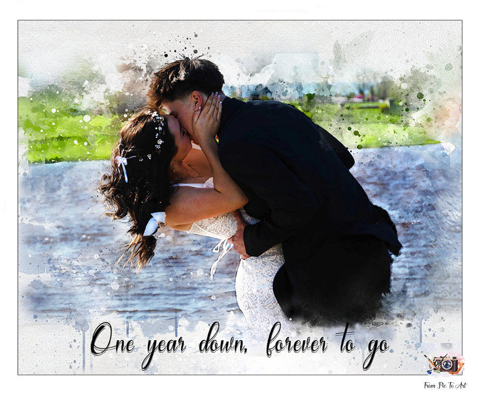 A watercolor-style image depicts a couple embracing and kissing, with the man holding the woman as she leans back. The woman is wearing what appears to be a white wedding dress with floral embellishments in her hair, and the man is in a dark suit. The background is a soft, blurred landscape with hints of green and blue, resembling an outdoor setting. At the bottom of the image, the text reads "One year down, forever to go.
