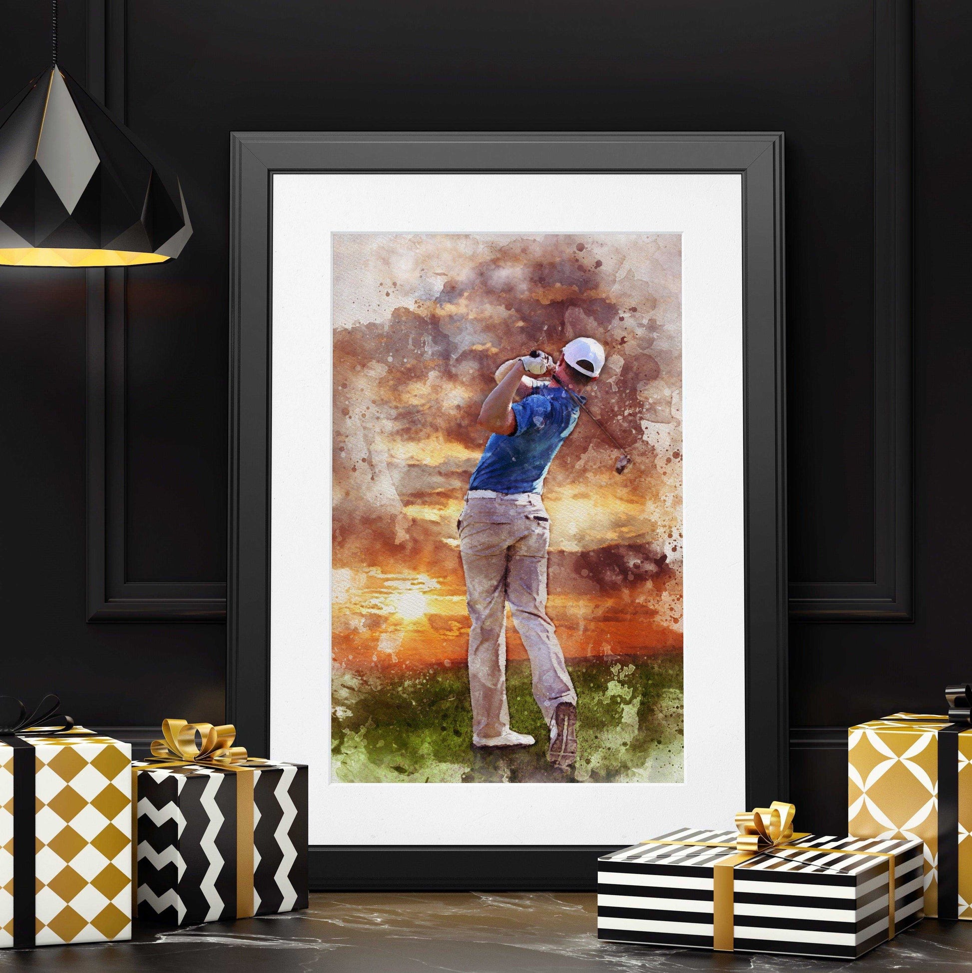 A framed watercolor golf art print of a male golfer mid-swing against a sunset backdrop is displayed amidst wrapped presents on a dark surface, under a modern black light fixture.